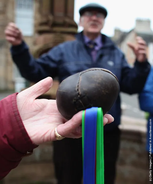 The leather ball is held before the start of the annual 'Fastern Eve Handba' event in Jedburgh's High Street in the Scottish Borders in Jedburgh, Scotland