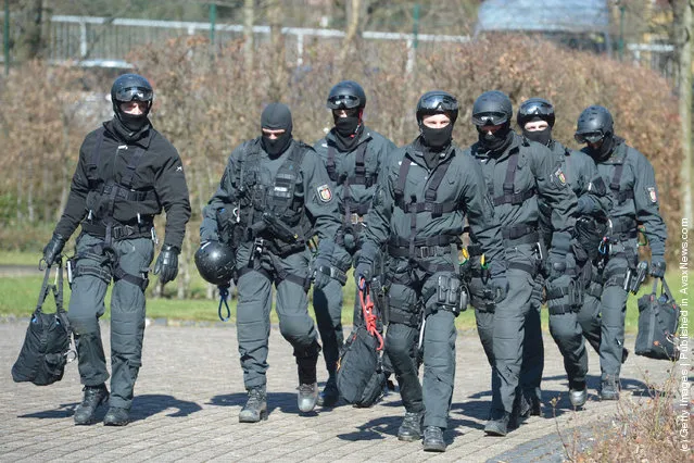Members of Germany's elite police unit, the Spezialeinsatzkommando, or SEK, leave the building after demonstrating an abseil deployment from a helicopter during a media event
