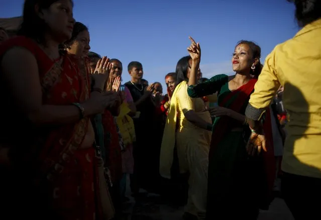 Devotees sing and dance at Pashupatinath temple to mark the Shrawan Sombar festival in Kathmandu, July 27, 2015. (Photo by Navesh Chitrakar/Reuters)
