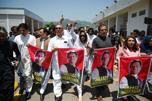 Parliamentarians of the Pakistan Tehreek-e-Insaf (PTI) party, carry posters of jailed former prime minister Imran Khan, during a protest outside the Parliament house in Islamabad on July 18, 2024. Pakistan's government will seek to ban the political party of jailed ex-prime minister Imran Khan, the information minister said on July 15, days after twin court decisions that favoured the former leader. (Photo by Aamir Qureshi/AFP Photo)