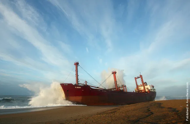 A wave brakes on the stranded TK Bremen, near Lorient, France, on December 17, 2011