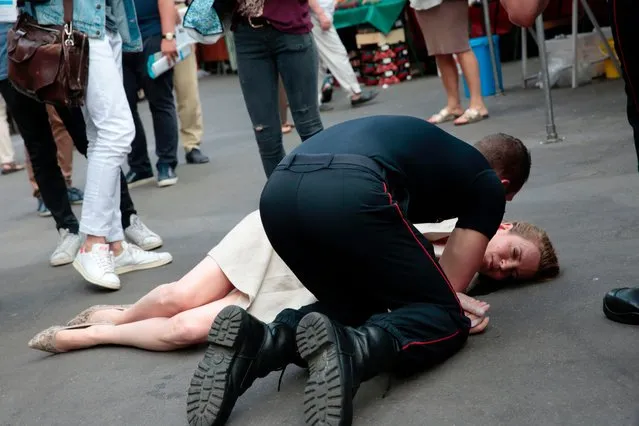 A firefighter gives assistance after Les Republicains (LR) party candidate Nathalie Kosciusko- Morizet collapsed while campaigning in the 5th arrondissement in Paris on June 15, 2017, ahead of the second round of the French legislative election. (Photo by Geoffroy Van Der Hasselt/AFP Photo)