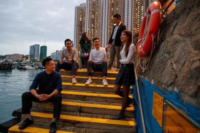 Newly elected district councillors Lee Yue-Shun, Tat Cheng, Karrine Fu, Jason Chan, James Pui and Jocelyn Chau (L-R) pose for a photo at the water front in front of the Eastern District Council building in Hong Kong, China, December 17, 2019. (Photo by Thomas Peter/Reuters)