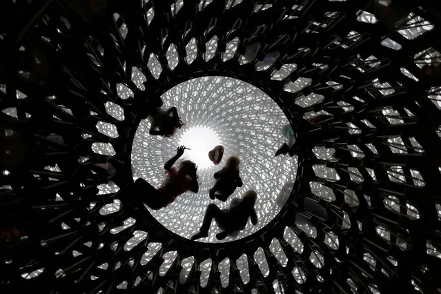 Children play inside the Hive, designed by artist Wolfgang Buttress, at Kew Gardens, in London, Britain July 1, 2017. (Photo by Andrew Winning/Reuters)