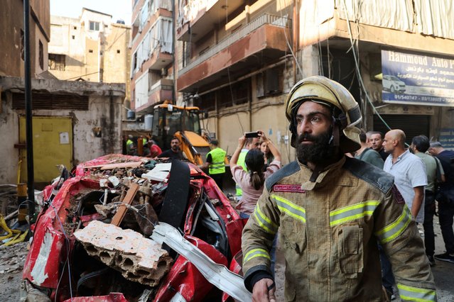 A firefighter works at the site of an Israeli strike, in Beirut's southern suburbs, Lebanon on September 24, 2024. (Photo by Amr Abdallah Dalsh/Reuters)