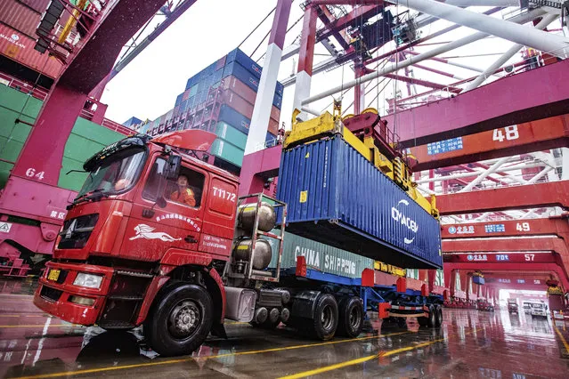 A worker waits to transport containers at the container port in Qingdao in eastern China's Shandong province on Tuesday, January 14, 2020. China's exports rose 0.5% in 2019 despite a tariff war with Washington after growth rebounded in December on stronger demand from other markets. (Photo by Chinatopix via AP Photo)
