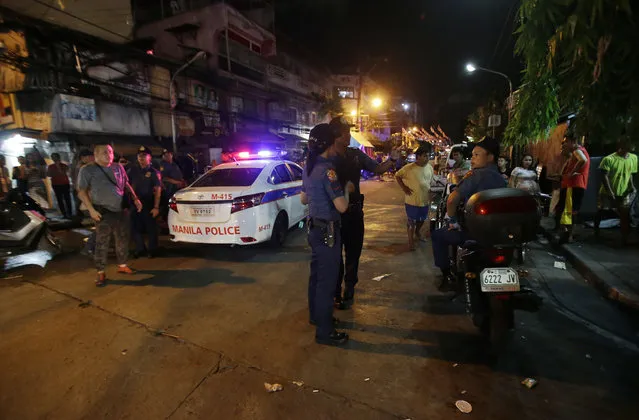 In this June 8, 2016 file photo, police conduct an overnight curfew for minors in Manila, Philippines. Even before he takes his oath of office on Thursday, Philippine President-elect Rodrigo Duterte's vow to kill drug criminals appear already being rolled out. Dozens of suspected drug criminals have either been killed in shootouts with police or mysteriously found dead on the streets in what some fear is a portent of things to come. (Photo by Aaron Favila/AP Photo)