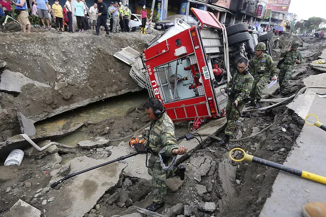 Rescue personnel survey the wreckage after an explosion in Kaohsiung, southern Taiwan, August 1, 2014. The explosion caused by a gas leak in Taiwan's second city killed 22 people, injured 270 and sent flames shooting 15 storeys into the air, a government agency said. (Photo by Toby Chang/Reuters)