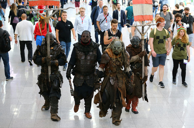 People dressed up as Middle-earth: Shadow of War game characters are seen during the world's largest computer games fair Gamescom in Cologne, Germany, August 22, 2017. (Photo by Wolfgang Rattay/Reuters)