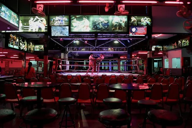 Muay Thai fighters perform at Walking Street inside an empty bar, lacking tourists, after the coronavirus outbreak in Pattaya, Thailand on March 11, 2020. (Photo by Chalinee Thirasupa/Reuters)
