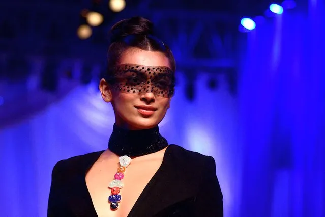 In this picture taken on July 29, 2022, an Indian model walks the ramp for Mijwan Welfare Society and fashion show by designer Manish Malhotra in Mumbai. (Photo by Sujit Jaiswal/AFP Photo)