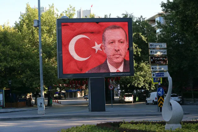A portrait of Turkey's President Recep Tayyip Erdogan appears on a billboard in Tunali Hilmi Street in Ankara, Turkey, Saturday, July 16, 2016. Forces loyal to Turkey's President Recep Tayyip Erdogan quashed a coup attempt in a night of explosions, air battles and gunfire that left dozens dead Saturday. Authorities arrested thousands of people as President Recep Tayyip Erdogan vowed those responsible “will pay a heavy price for their treason”. (Photo by Burhan Ozbilici/AP Photo)