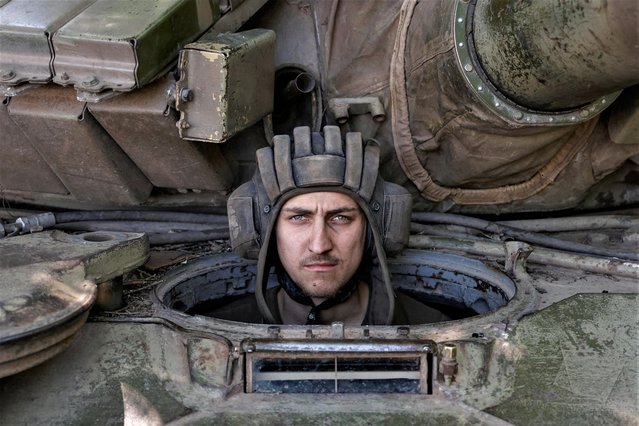 A Ukrainian serviceman looks on from inside a tank at a position in Donetsk region, as Russia's attack on Ukraine continues, Ukraine on June 11, 2022. (Photo by Reuters/Stringer)