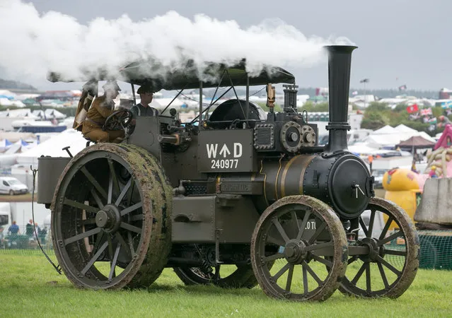 A steam road locomotive that is part of the World War One Commemorative Display drives through the main arena at the Great Dorset Steam Fair in Tarrant Hinton near Blandford on August 28, 2014 in Dorset, England. Heavy rain has disrupted the opening of the event, which is in its 45th year and regularly attracts 200,000 visitors to the site to see steam road locomotive, as well as other vintage vehicles. (Photo by Matt Cardy/Getty Images)