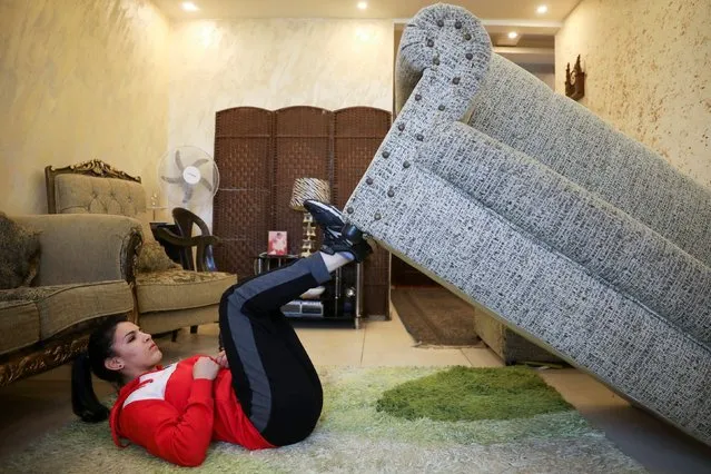 Hadeel Alami, a Jordanian judo practitioner, uses the sofa as a part of her trainings at her home during the curfew imposed by the government amid concerns over the spread of the coronavirus disease (COVID-19), in Amman, Jordan, April 9, 2020. (Photo by Muhammad Hamed/Reuters)