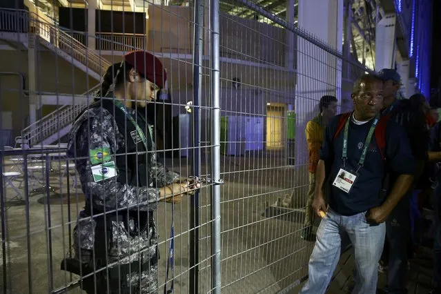 A guard locks a gate at the media entrance to the Olympics Aquatics Stadium during a security alert in Rio de Janeiro, Brazil, on August 2, 2016. (Photo by Vasily Fedosenko/Reuters)