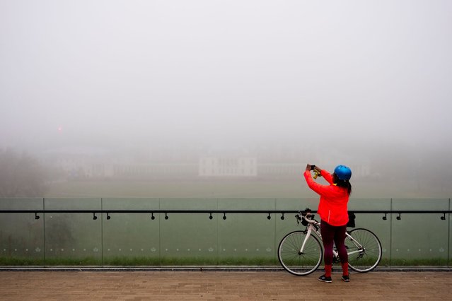 A cyclist in foggy weather in Greenwich Park in London on Friday, December 27, 2024. The UK will have dull and drizzly weather over the coming days, with a “wet and rather windy” New Year's Eve on the horizon, the Met Office has said. (Photo by Jordan Pettitt/PA Images via Getty Images)