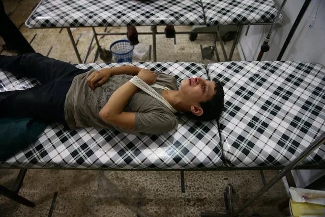 An injured youth reacts inside a field hospital after shelling in the rebel held Douma neighborhood of Damascus, Syria July 21, 2016. (Photo by Bassam Khabieh/Reuters)