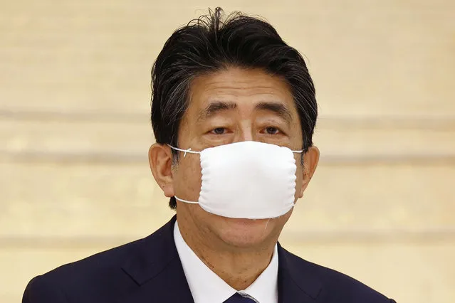 Japan's Prime Minister Shinzo Abe speaks during a meeting of government and ruling party officials at his office in Tokyo Wednesday, May 27, 2020. Japan’s Cabinet has approved a proposed 32 trillion-yen ($296 billion) supplementary budget to help fund measures to cushion the blow to the economy from the coronavirus pandemic. (Photo by Kyodo News via AP Photo)