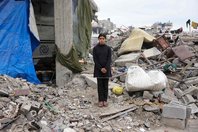 Maram Al-Assali, 12, poses in front of her destroyed home in Jabalia, northern Gaza Strip, on February 9, 2025. (Photo by Bashar Taleb/AFP Photo)