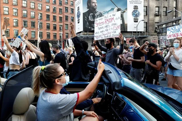 Demonstrators march as cars are stopped during a protest against racial inequality in the aftermath of the death in Minneapolis police custody of George Floyd, in New York, U.S., June 15, 2020. (Photo by Shannon Stapleton/Reuters)