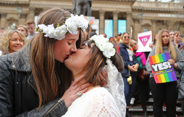 A couple kiss at the conclusion of an Illegal Wedding at the State Library of Victoria during a Rally For Marriage Equality on August 26, 2017 in Melbourne, Australia. This month marks thirteen years since the Marriage Act was amended to restrict marriage rights to heterosexual couples. Australia is now preparing for postal vote on whether same-s*x marriage should be legalised. The Australian Marriage Law Postal Survey is due to be sent out by the Australian Bureau of Statistics on September 12. (Photo by Scott Barbour/Getty Images)