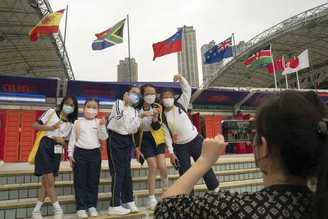 A student group poses for a photograph in front of the Hong Kong Stadium ahead of the first day of the Hong Kong Sevens rugby tournament in Hong Kong, Friday, November 4, 2022. (Photo by Anthony Kwan/AP Photo)