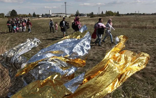 Migrants pass first aid blankets at the Austria-Hungaria border, walking towards Nickelsdorf, Austria, September 20, 2015. (Photo by David W. Cerny/Reuters)