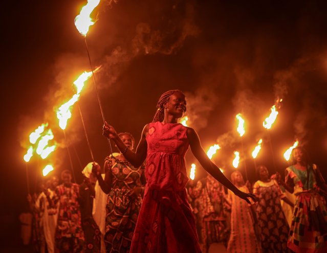 Ethnic groups in the village of Mbourokh near the city of Mbour are viewed dancing in a large circle around the tourists with torches in their hands in Mbour, Senegal on January 05, 2024. In Senegal, the “surprise” dinner organized with the dance and music of ethnic groups among baobab trees offers colorful slices of Senegalese culture and gives foreign tourists pleasant moments. Ethnic groups in the village of Mbourokh, about 100 kilometers from the capital Dakar, present their unique dances and rituals to visitors. (Photo by Cem Ozdel/Anadolu via Getty Images)