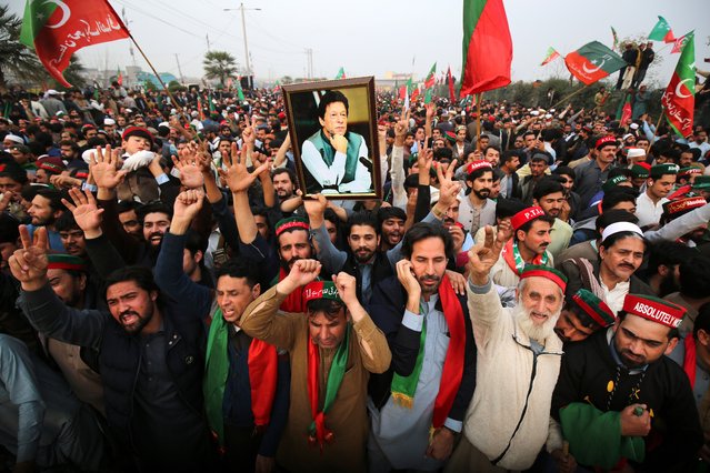 A man holds a picture of convicted former Pakistani Prime Minister Khan as supporters of his Pakistan Tehrik-e-Insaf (PTI) political party as they gather to protest against alleged rigging in the general elections, in Peshawar, Pakistan, 17 February 2024. Former prime minister Imran Khan's Pakistan Tehreek-e-Insaf (PTI) party has called for nationwide protests on 17 February, against alleged election rigging in Pakistan. The PTI accuses the election commission of widespread rigging, claiming that their victory in the February 8 elections was cut in half. The election commission denies the accusations and says there are legal forums to address concerns. (Photo by Arshad Arbab/EPA/EFE)