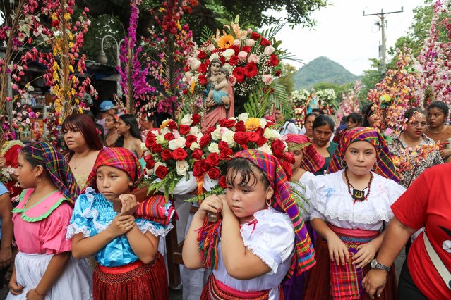 Young women in indigenous 'Panchitas' attire accompanying a procession during the 43rd Cultural Festival of Palms and Flowers held in the colonial city of Panchimalco, in San Salvador, El Salvador on May 11, 2025. It is a cultural and religious tradition where people carry coconut palms decorated with all kinds of flowers that coincides with the beginning of the rainy season in El Salvador. (Photo by Alex Pena/Anadolu via Getty Images)