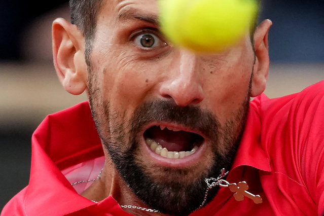 Serbia's Novak Djokovic eyes the ball as he plays a backhand return to Italy's Jannik Sinner during their men's singles semi-final match on day 13 of the French Open tennis tournament on Court Philippe-Chatrier at the Roland-Garros Complex in Paris on June 6, 2025. (Photo by Dimitar Dilkoff/AFP Photo)