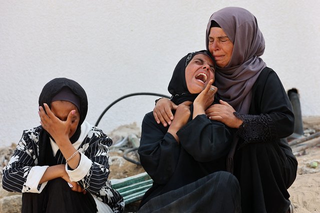 Women cry as they mourn the death of a loved one killed during overnight Israeli bombardment on June 12, 2025, at al-Shifa hospital in Gaza City, amid the ongoing war between Israel and the Palestinian Hamas militant group. (Photo by Omar Al-Qattaa/AFP Photo)