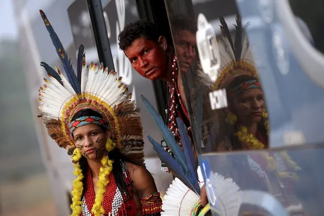 Indigenous people from the Pataxo tribe look out of a bus as they arrive to participate in the I World Games for Indigenous People in Palmas, Brazil, October 20, 2015. (Photo by Ueslei Marcelino/Reuters)