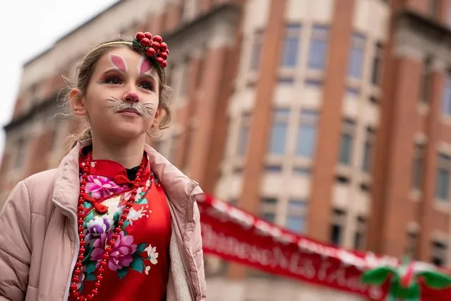 A child marches in the Lunar New Year Parade in the Chinatown neighborhood of Washington, DC, on January 22, 2023. 2023 is the year of the rabbit in the Chinese horoscope. (Photo by Stefani Reynolds/AFP Photo)