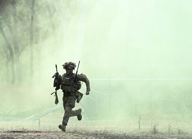 An Australian soldier from Battle Group Kapyong conducts a clearance of an enemy position on July 24, 2025 in Townsville, Australia. Over 30,000 military personnel from 19 nations are participating in Exercise Talisman Sabre 2025, the largest-ever joint military drills held across Australia and, for the first time, Papua New Guinea, focusing on multi-domain operations including land, sea, air, space, and cyber warfare. (Photo by Ian Hitchcock/Getty Images)