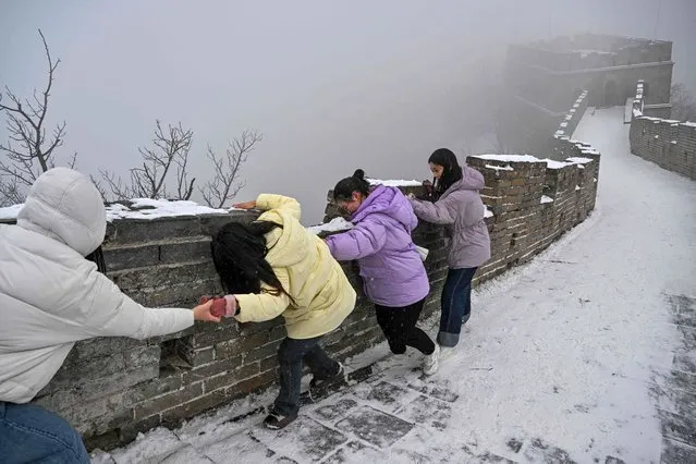 People visit the Great Wall in Mutianyu in the Huairou district, over 70km from Beijing on February 12, 2023. (Photo by Hector Retamal/AFP Photo)