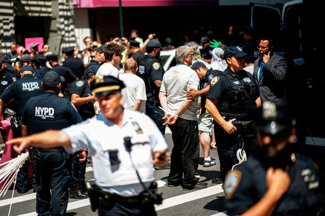 Demonstrators are detained after blocking the street during a protest called March Against Immigration Cruelty outside the U.S. immigration court in Manhattan on August 11, 2025. (Photo by Eduardo Munoz/Reuters)