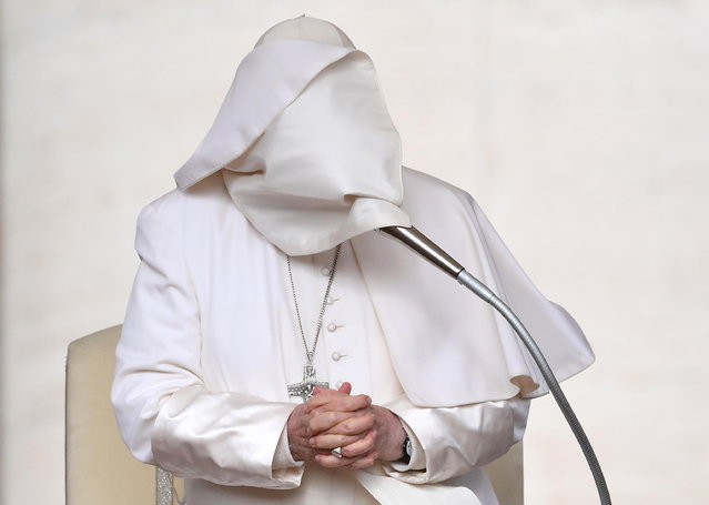 The cape covers the face of Pope Francis as he leads the weekly general audience in Saint Peter's Square, Vatican City, 10 April 2024. (Photo by Ettore Ferrari/EPA)
