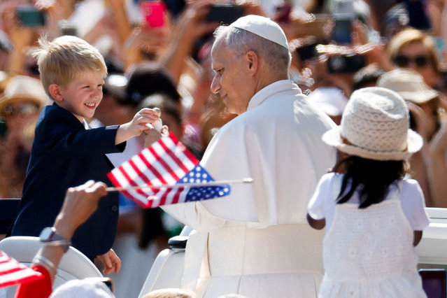 Pope Leo XIV interacts with a child, on the day he holds a general audience in St. Peter's Square, at the Vatican, on August 6, 2025. (Photo by Remo Casilli/Reuters)