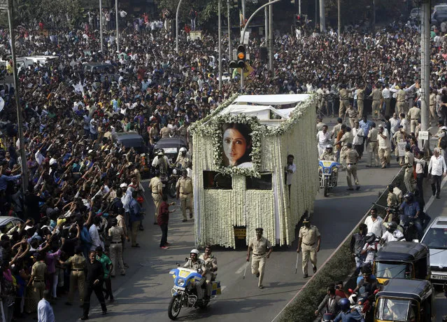 The body of Indian actress Sridevi is carried in truck during her funeral in Mumbai, India, Wednesday, February 28, 2018. Lining up for hours and visibly grief-stricken, thousands of mourning fans paid their respects Wednesday to Sridevi, the iconic Bollywood actress who drowned accidentally in a Dubai hotel bathtub over the weekend. (Photo by Rajanish Kakade/AP Photo)