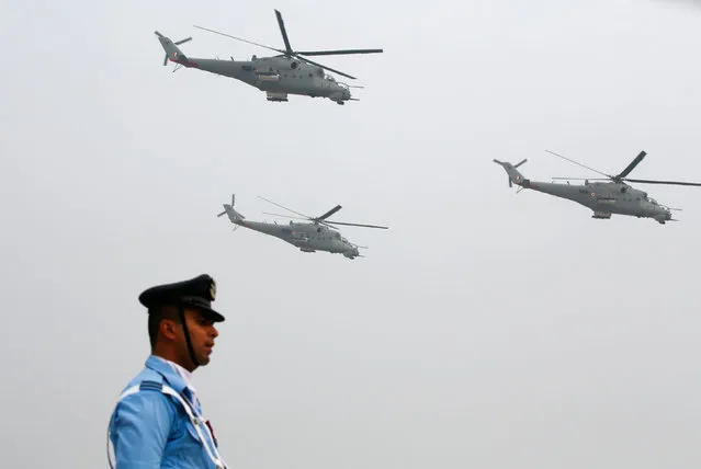 An Indian Air Force soldier marches as Mil Mi-35 helicopters fly over during the full-dress rehearsal for Indian Air Force Day at the Hindon air force station on the outskirts of New Delhi, India, October 6, 2016. (Photo by Adnan Abidi/Reuters)