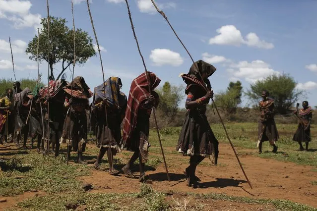 Pokot girls walk in line during an initiation ceremony of over a hundred girls passing over into womanhood, about 80 km (50 miles) from the town of Marigat in Baringo County December 6, 2014. (Photo by Siegfried Modola/Reuters)