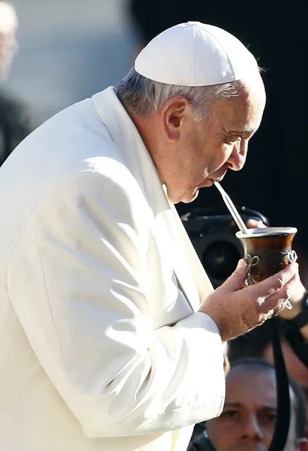 Pope Francis, who's 78th birthday is today, drinks mate tea, also known as yerba, a traditional South American drink, as he arrives to lead his general audience at the Vatican, December 17, 2014. (Photo by Tony Gentile/Reuters)