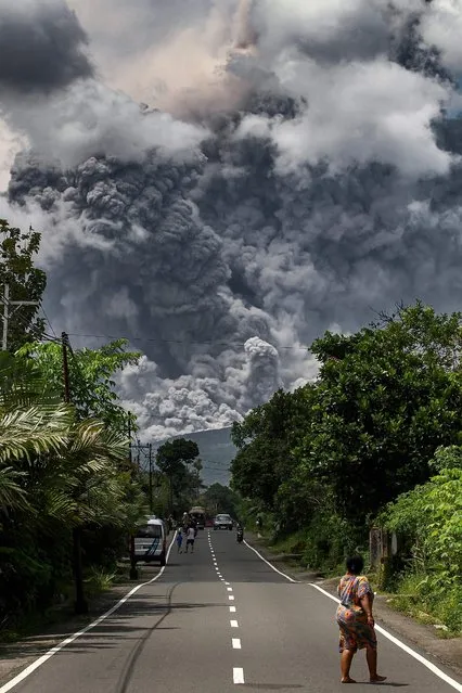 Thick smoke rises during an eruption from Mount Merapi, Indonesia's most active volcano, as seen from Tunggularum village in Sleman on March 11, 2023. (Photo by Devi Rahman/AFP Photo)