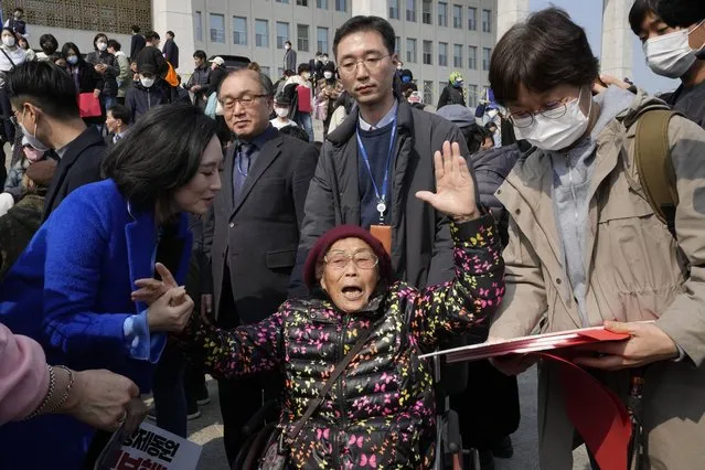 South Korean forced labor victim Yang Geum-deok, bottom center, reacts after a rally against the South Korean government's announcement of a plan over the issue of compensation for forced labors at the National Assembly in Seoul, South Korea, Tuesday, March 7, 2023. South Korean President Yoon Suk Yeol on Tuesday defended his government's contentious plan to use local funds to compensate Koreans enslaved by Japanese companies before the end of World War II, saying it's crucial for Seoul to build future-oriented ties with its former colonial overlord. (Photo by Ahn Young-joon/AP Photo)