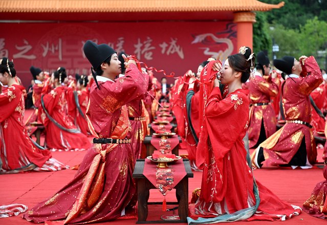 Newly-wed couples dressed in Tang-style costumes participate in a group wedding on October 28, 2025 in Fuzhou, Fujian Province of China. (Photo by Lyu Ming/China News Service/VCG via Getty Images)