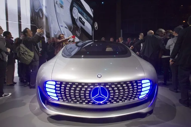 Journalist surround the Mercedes-Benz F015 Luxury in Motion autonomous concept car after it was unveiled during the 2015 International Consumer Electronics Show (CES) in Las Vegas, Nevada January 5, 2015. Germany's Daimler AG wants to reset consumers' expectations about self-driving cars with its futuristic Mercedes-Benz F 015 concept, unveiled Monday evening at the annual Consumer Electronics Show in Las Vegas. (Photo by Steve Marcus/Reuters)
