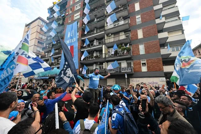 Napoli supporters wave team flags and a flags and cheer in Naples, on April 30, 2023, prior to the Italian Serie A football match between Napoli and Salernitana. Naples braces for its potential first Scudetto championship win in 33 years. With a 17 point lead at the top of Serie A, southern Italy's biggest club is anticipating its victory in the Scudetto for the first time since 1990. (Photo by Andreas Solaro/AFP Photo)
