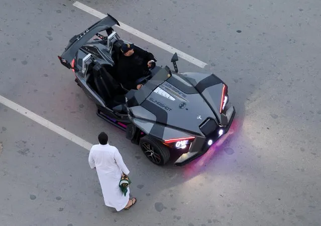 A muslim man stands next to a man in a Batman-themed car, after Eid al-Fitr prayers to mark the end of the holy fasting month of Ramadan in front of “El Aziem” (Mosque of The Great) in Cairo suburb of Maadi, Egypt on April 21, 2023. (Photo by Amr Abdallah Dalsh/Reuters)